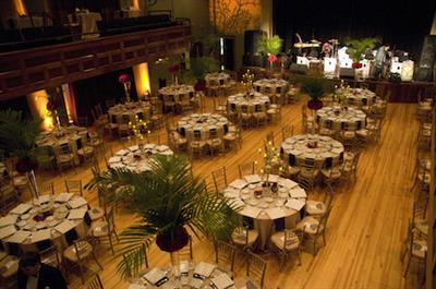 decorated banquet hall with circular tables and chairs