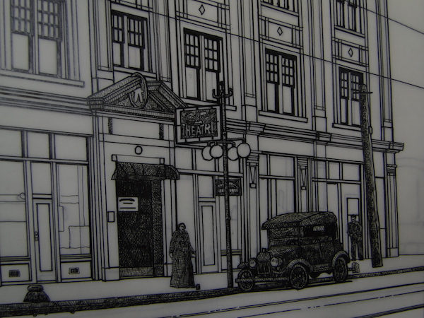 sketch of side of building with car and person and lamp post