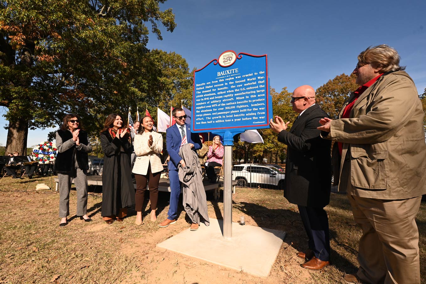 Arkansas State Staff unveil the Bauxite Arkansas250 Marker.