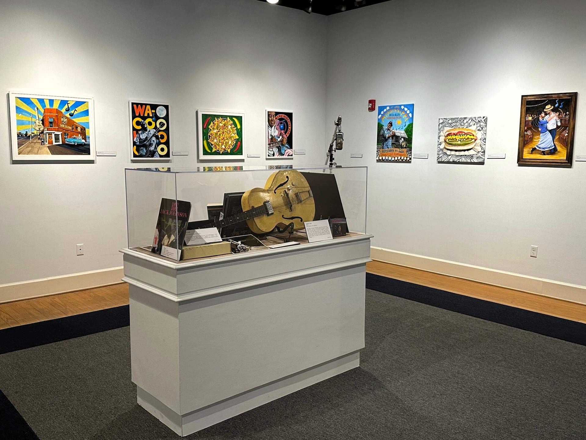 Exhibit at Delta Cultural Center showing art and instruments.