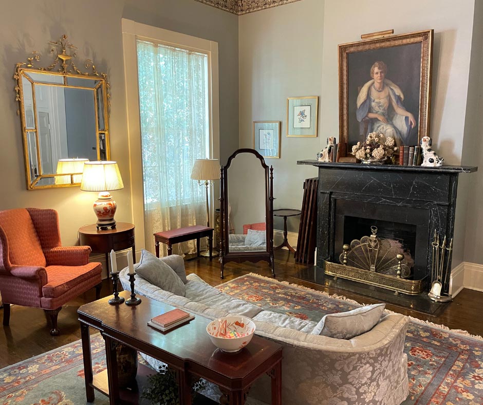 Room in Trapnall Hall filled with vintage furniture and art.