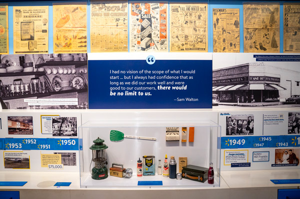 Exhibit wall full of facts and images about the history of Walmart.