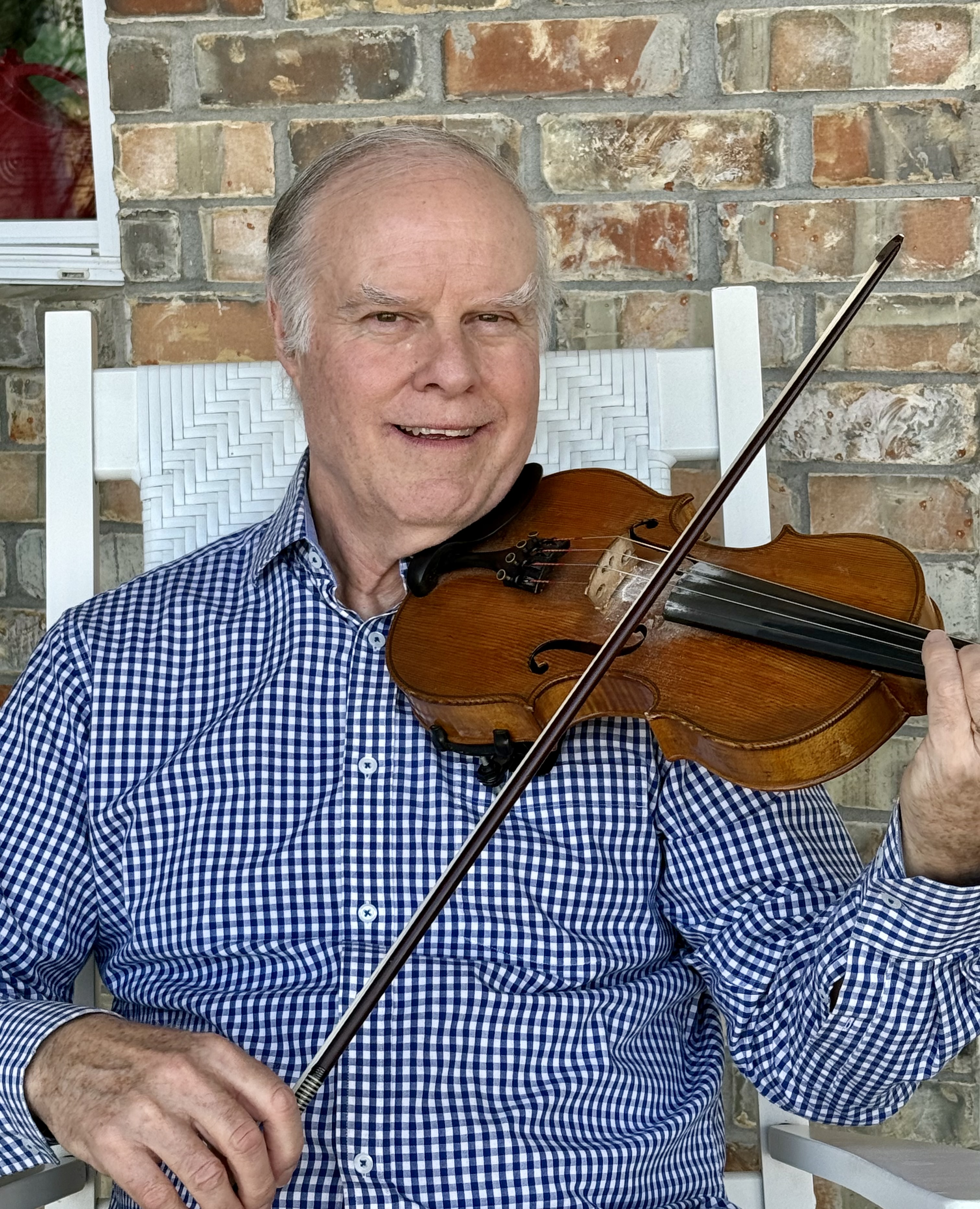 Tim Trawick holds a fiddle after being named as an Arkansas Living Treasure.