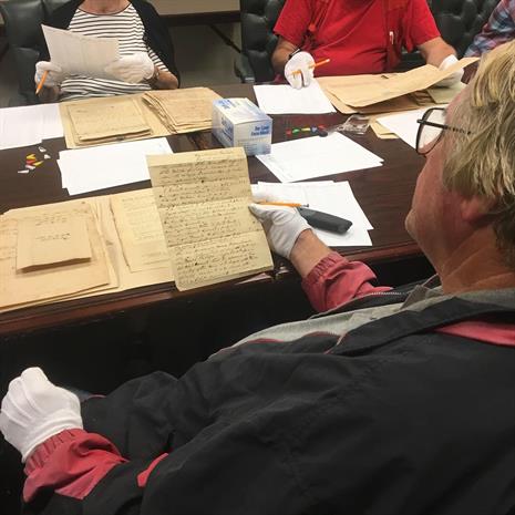 woman looking at document with gloves on