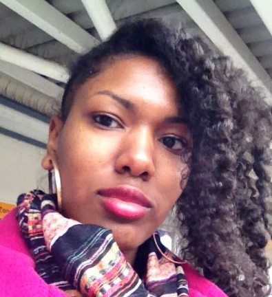 selfie image of woman staring with patterned scarf