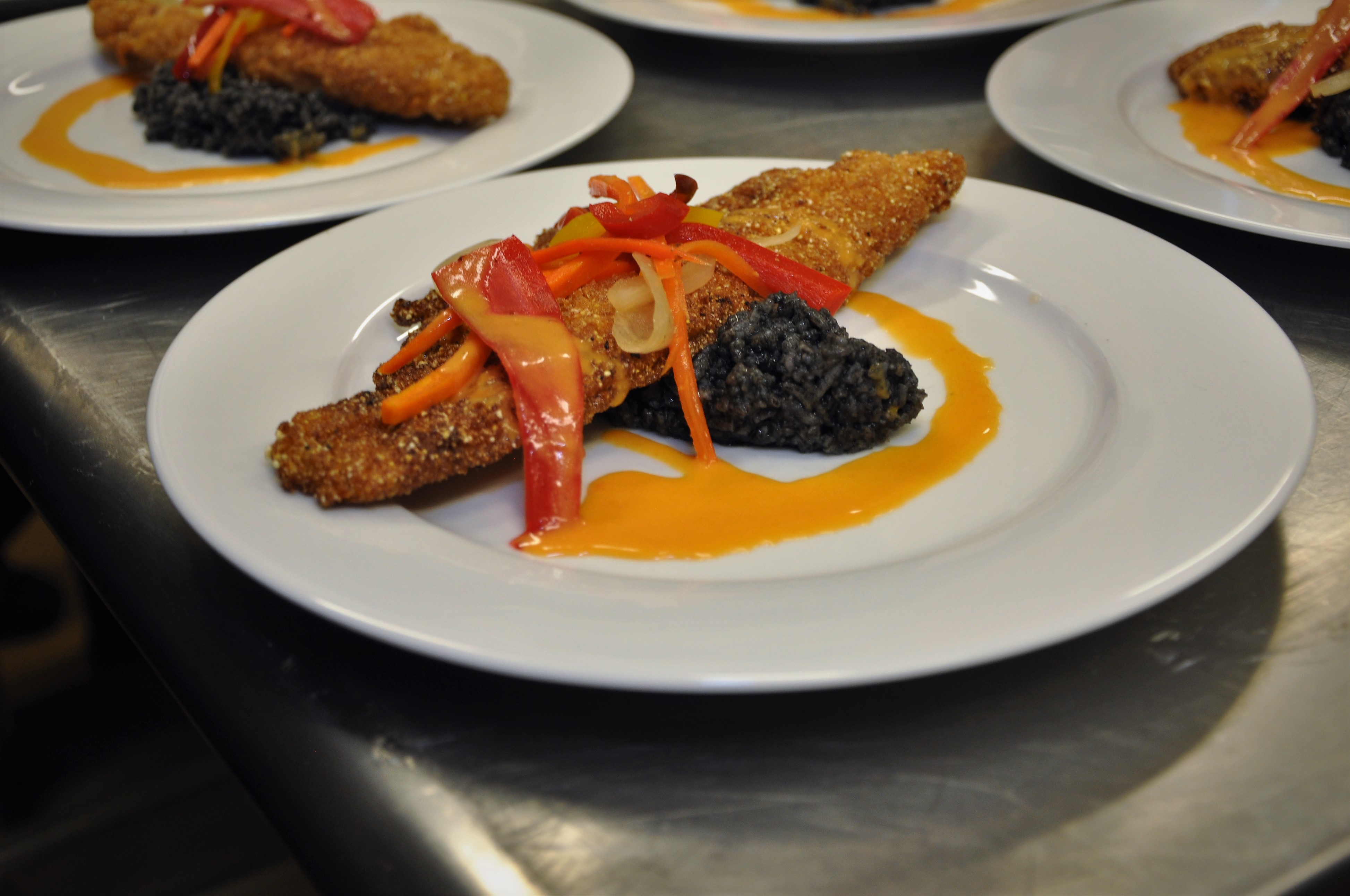 decoratively plated colorful food with sauce drizzle 