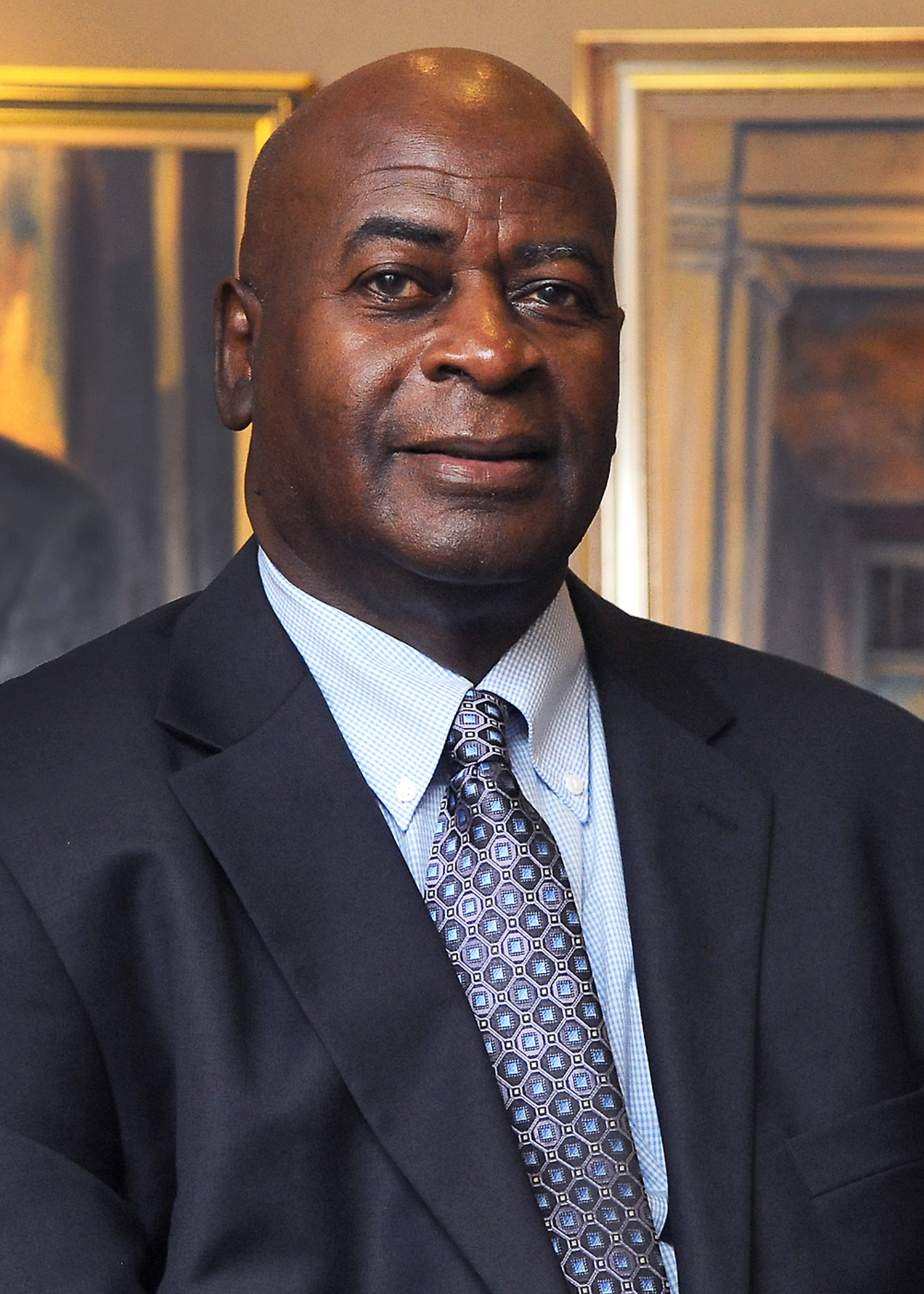 profile headshot of man in suit with tie
