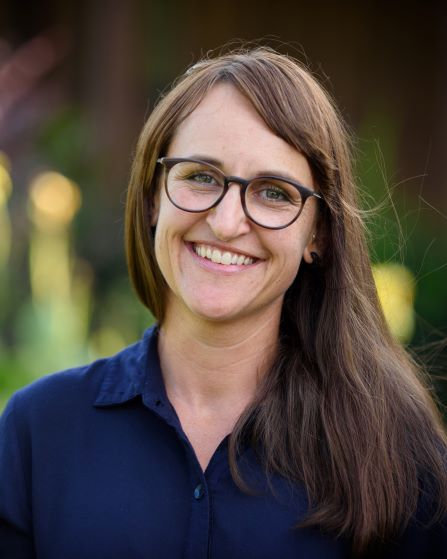 headshot of woman wearing glasses and smiling