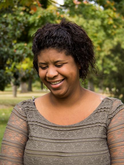 headshot of woman smiling and looking down
