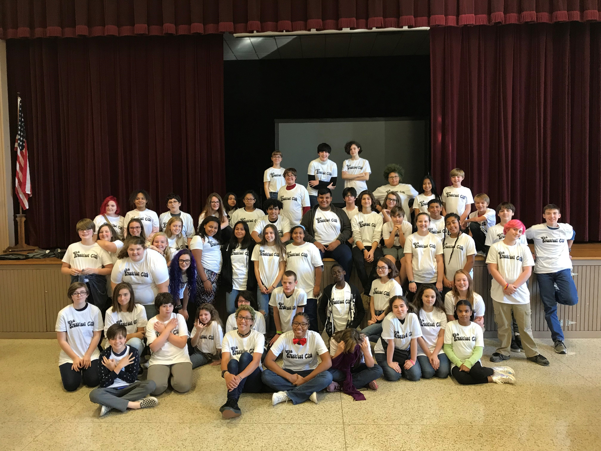 group picture of kids wearing matching white breakfast club t-shirts