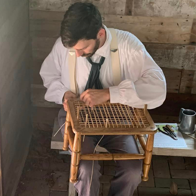Man caning a chair
