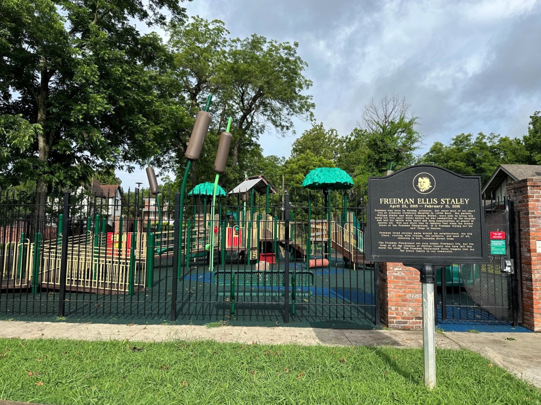 Freeman Playground from behind the fence showing the Historical Marker