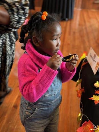 One of the cutest attendees samples an entry
