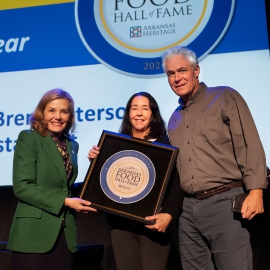 Stacy Hurst, Capi Peck, and Brent Peterson with the award from Food Hall of Fame