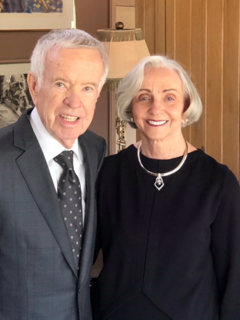 picture of the faulkners standing next to one another dressed in suite and with necklace