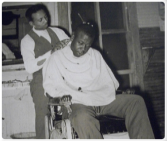 man getting haircut in barber chair