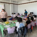 Agroupofstudentssittingatcoveredtablespainting