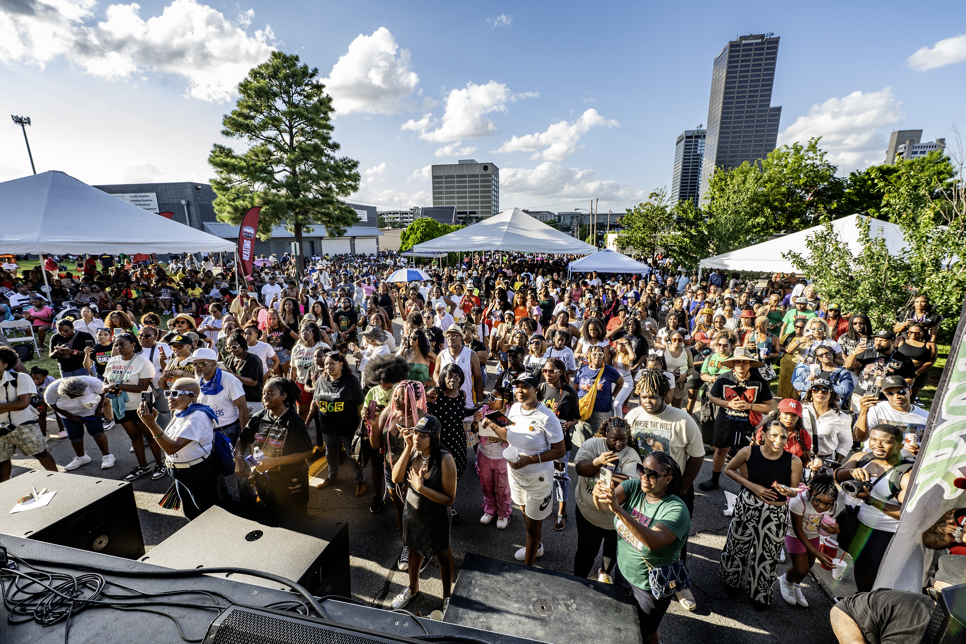 Fromthestagelookingatagroupofpeoplefacingthestageandwatchingperformances