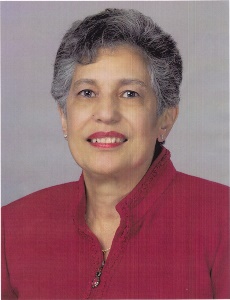 Anolderwomanwithshorthairinaredblouseposingandsmiling