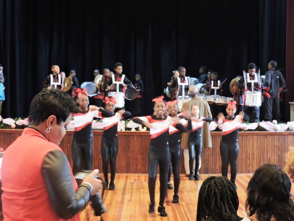 girlsindanceuniformsperformingonfloorinfrontofstage
