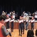girlsindanceuniformsperformingonfloorinfrontofstage