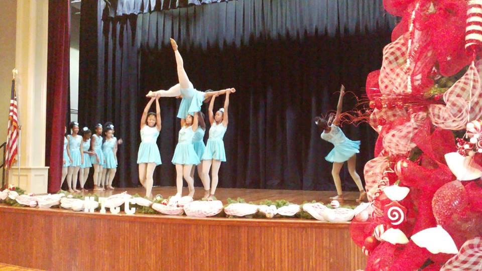 girlsinlightblueleotarddanceoutfitsdancingandperformingonstage