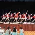 girlsinSanta-styledanceoutfitsperformingonstage