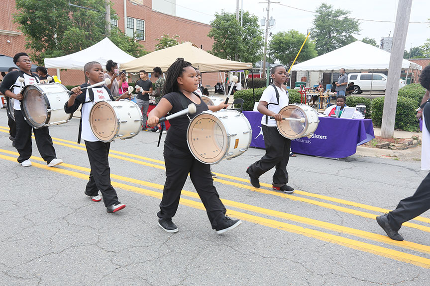 kidswearingplayingdrumsmarchingdownthestreet