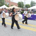kidswearingplayingdrumsmarchingdownthestreet