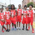girlsinredbasketballuniformsandsandalssmiling