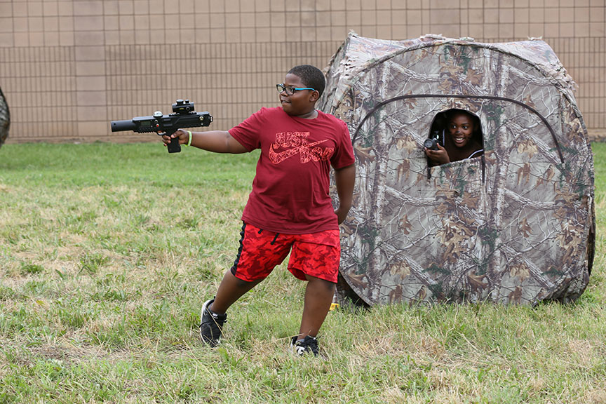 kidwithgunandkidincamouflagehuntingtent