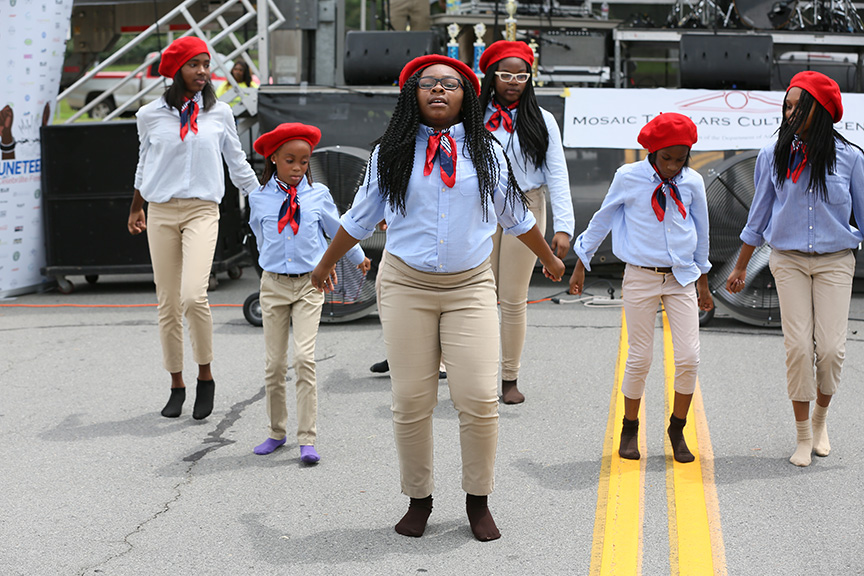 girlsinkhakipantsbluebutton-upshirtsandredscarfsandberetswearingsocksanddancing