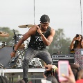 maninblackbaseballcaptanktopandgrayjeansdancingonstage