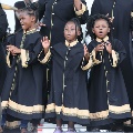 younggirlsintraditionalculturalrobessinginganddancingonstage