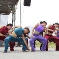 womeninvariouscolorsofdancecostumesmid-danceonstreet