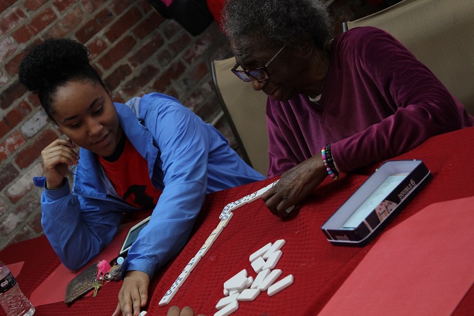 girlandolderwomanplayingdominoes