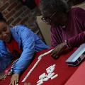 girlandolderwomanplayingdominoes