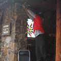 personhangingdecorativelightsonstonebuilding