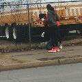 peopleonsidewalkbymetalfencepickinguptrash