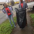 girlswithtrashbagstandingonsidewalk