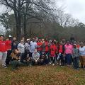 groupofpeoplestandingoutsideongrassbytrees