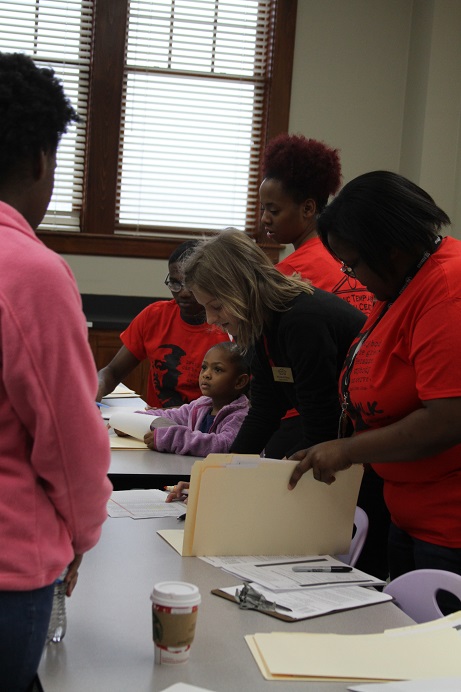 womenandyounggirllookingatfoldersofpaperwork