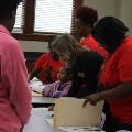 womenandyounggirllookingatfoldersofpaperwork