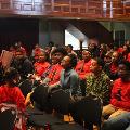 womanandyounggirlstandinginfrontofgroupspeaking