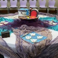 circulartablewithcakeinthecenterdesignedlikebucketsofpaintwithplatesofArkansas-shapedcookies