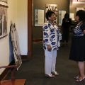 twowomenstandingbyphotographsandexhibitstalking