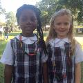 girlsinschooluniformswithfacepaintandnoodlenecklaces