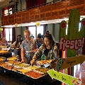 Peoplelinedupatabuffetgettingvariousfood