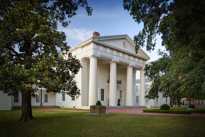 front side view of state house with trees and columns